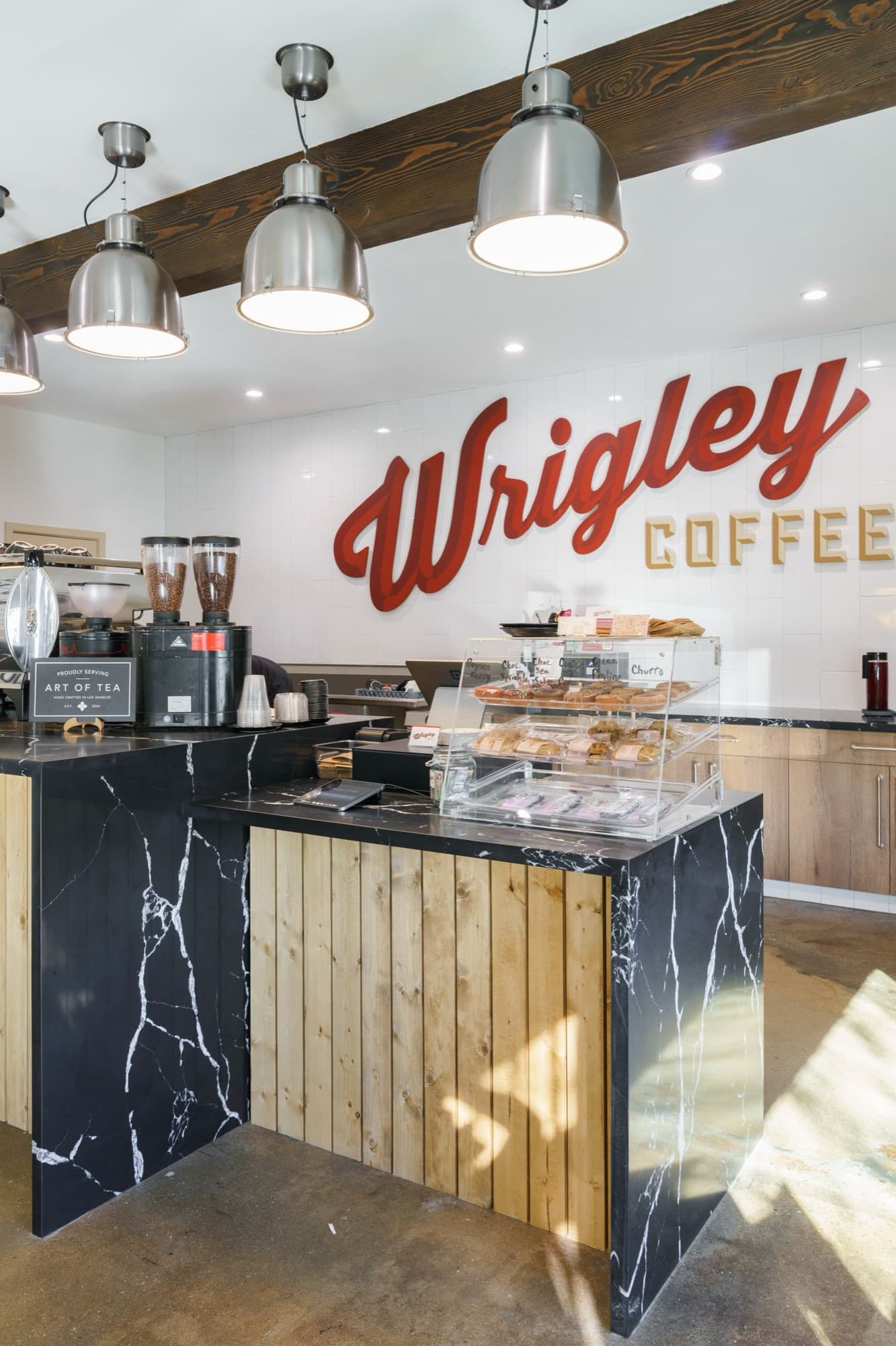 The Wrigley Coffee counter with pendant lights and the red Wrigley Coffee sign